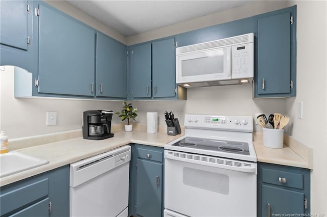 kitchen with white appliances, blue cabinets, and sink