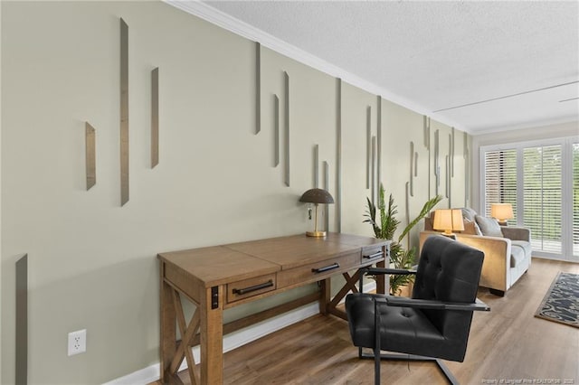 sitting room featuring hardwood / wood-style floors, a textured ceiling, and crown molding