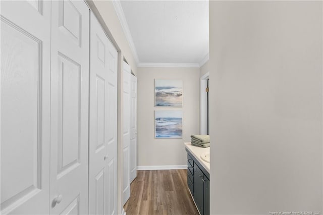 hallway featuring hardwood / wood-style flooring and ornamental molding