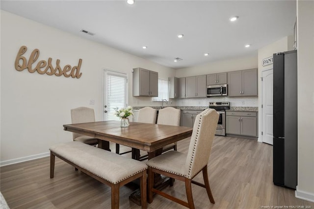 dining space with light hardwood / wood-style flooring