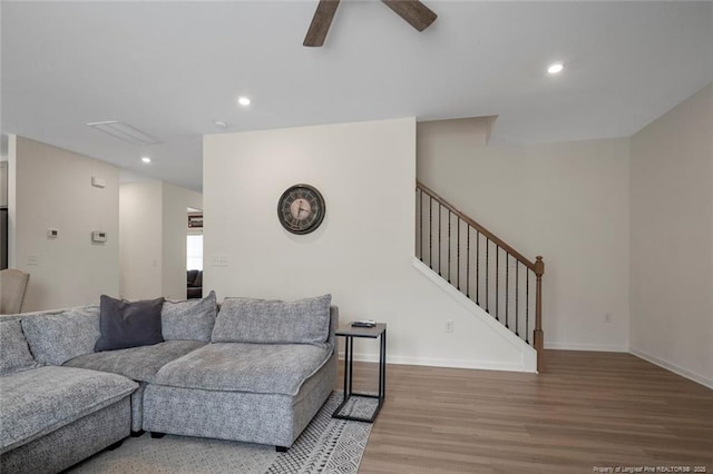 living room featuring hardwood / wood-style flooring and ceiling fan