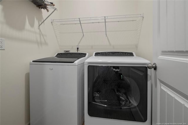 clothes washing area featuring washing machine and clothes dryer