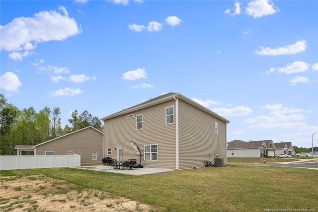 back of property featuring central AC, a patio area, and a lawn