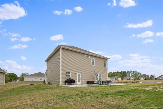 rear view of house featuring a yard and a patio area