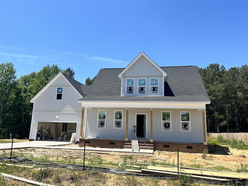 view of front of house with crawl space, covered porch, fence, and driveway