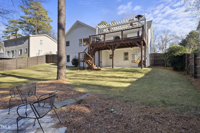 rear view of house with a lawn, a pergola, a patio, and a wooden deck