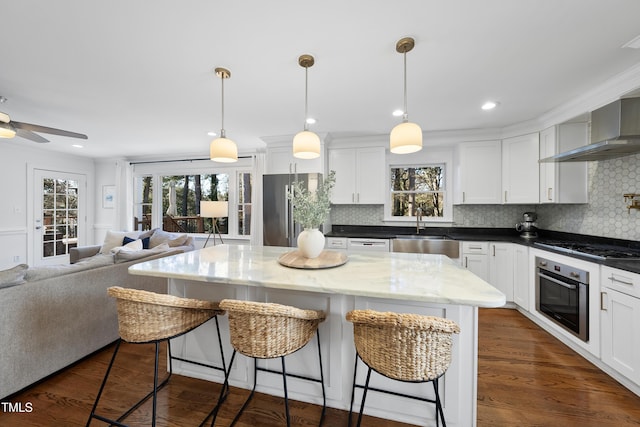 kitchen with dark wood-type flooring, appliances with stainless steel finishes, white cabinetry, and sink