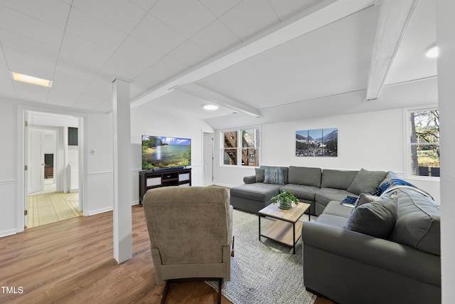 living room featuring beam ceiling and hardwood / wood-style floors