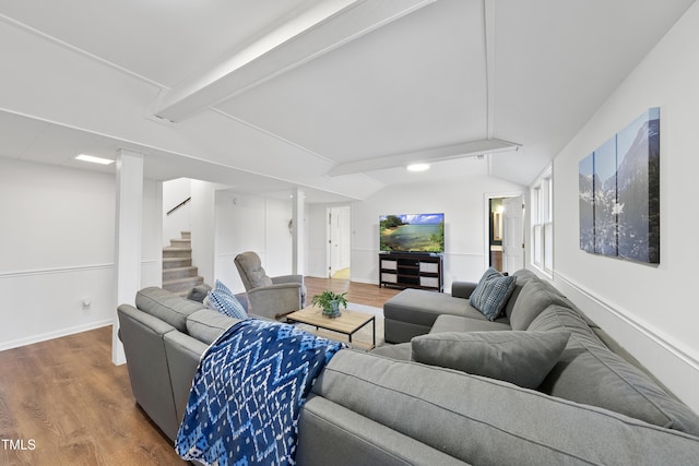 living room with hardwood / wood-style flooring and lofted ceiling with beams