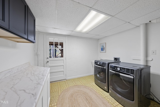 laundry room with cabinets and washer and clothes dryer