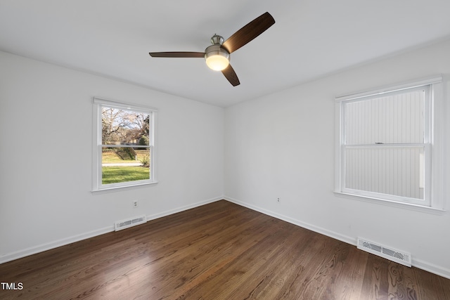 spare room featuring ceiling fan and dark wood-type flooring