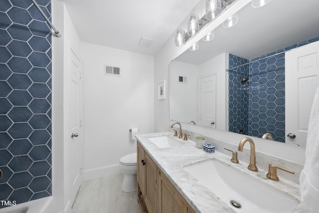 bathroom featuring toilet, vanity, and a shower