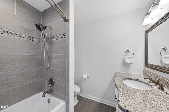 full bathroom with toilet, tiled shower / bath, and vanity