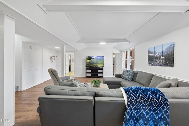 living room with hardwood / wood-style flooring and lofted ceiling with beams