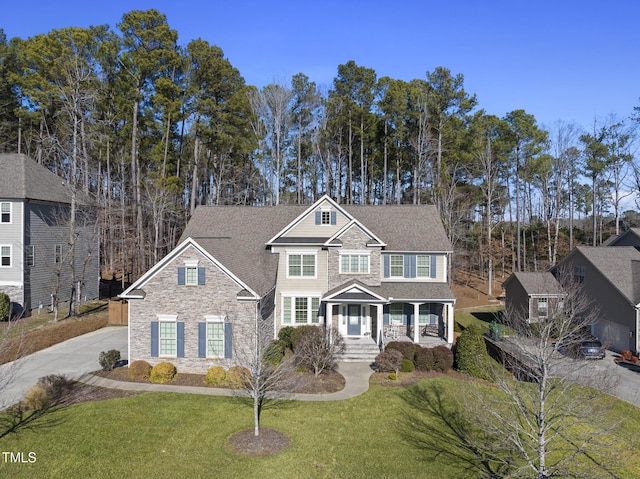 view of front of property featuring a front yard, a porch, and a shed