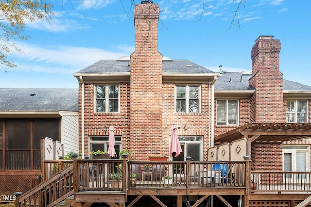 back of house featuring a wooden deck and a pergola