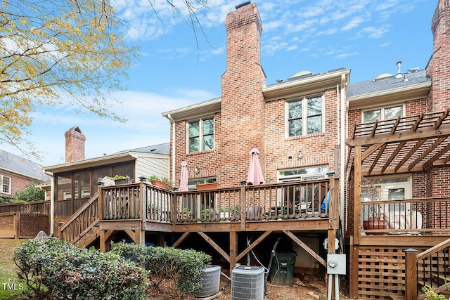 back of property featuring a wooden deck, a sunroom, a pergola, and central air condition unit