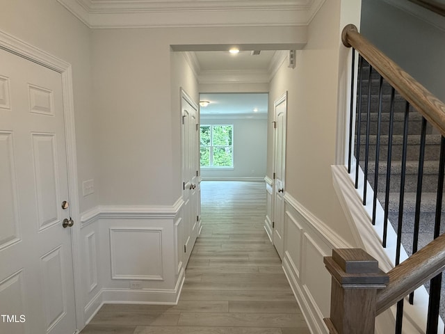 137 Stallion Way, Benson, NC 27504 - corridor featuring light wood-style floors, a decorative wall, ornamental molding, a wainscoted wall, and stairway