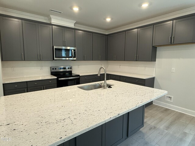 137 Stallion Way, Benson, NC 27504 - kitchen with appliances with stainless steel finishes, a sink, light stone countertops, ornamental molding, and baseboards