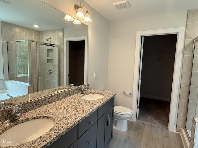 137 Stallion Way, Benson, NC 27504 - bathroom featuring wood finished floors, a shower stall, toilet, and a spacious closet