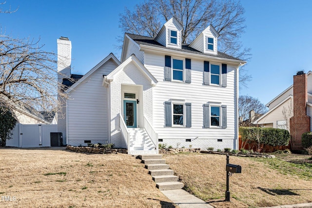 view of front of home with a front yard and central air condition unit