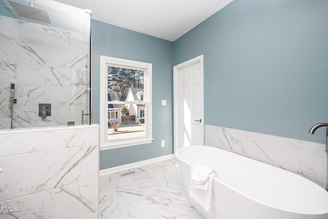 bathroom featuring shower with separate bathtub