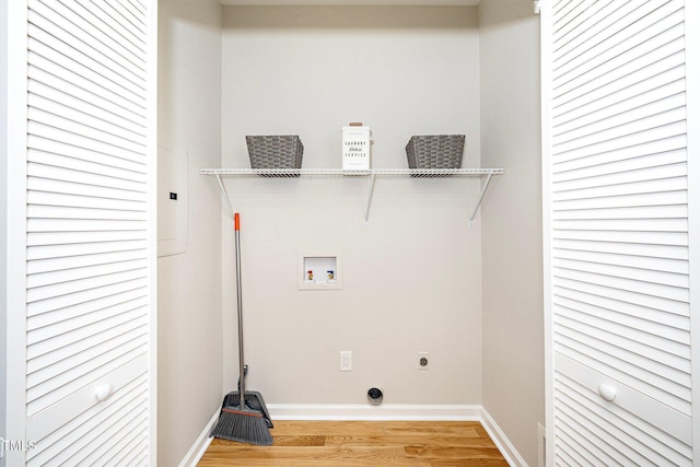 clothes washing area featuring hookup for an electric dryer, hookup for a washing machine, and hardwood / wood-style flooring