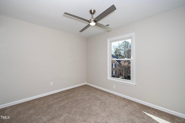 carpeted spare room featuring ceiling fan