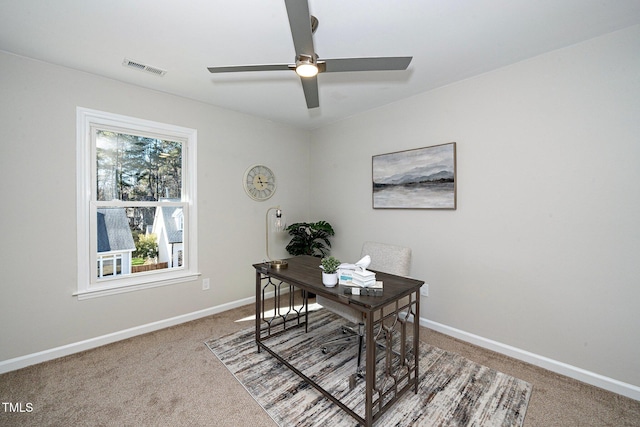 carpeted office space with ceiling fan