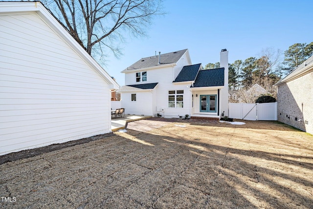 back of property with a patio area and french doors