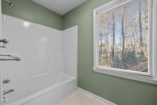 bathroom with shower / bathing tub combination and a wealth of natural light