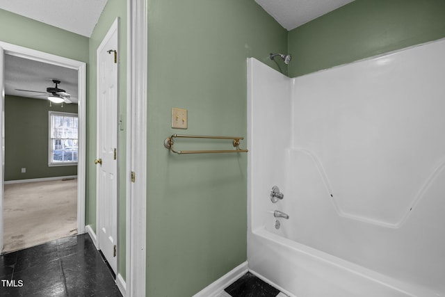 bathroom with ceiling fan, a textured ceiling, and shower / bathing tub combination