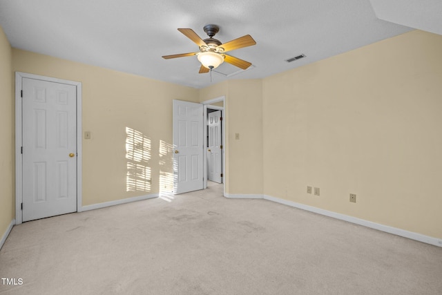 carpeted spare room with ceiling fan