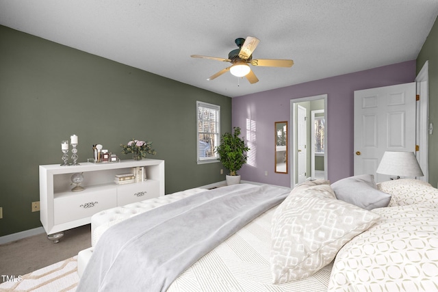 bedroom with a textured ceiling, ceiling fan, and carpet