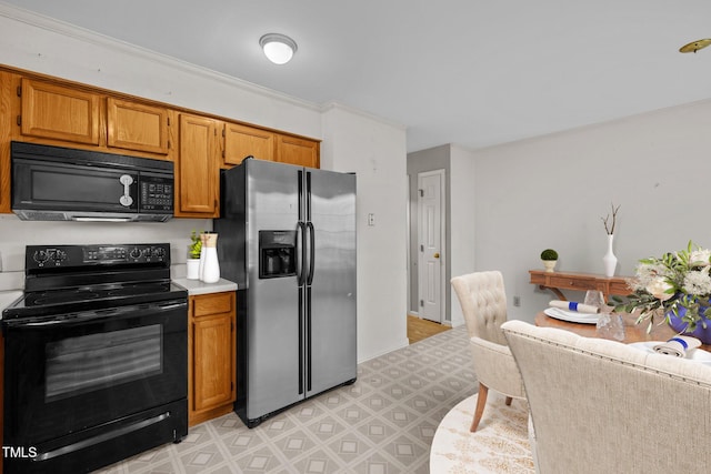 kitchen featuring black appliances and ornamental molding