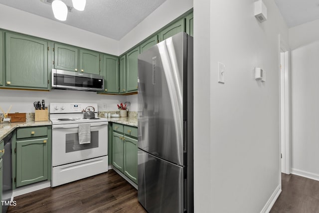 kitchen featuring green cabinets, light stone counters, dark hardwood / wood-style floors, a textured ceiling, and appliances with stainless steel finishes