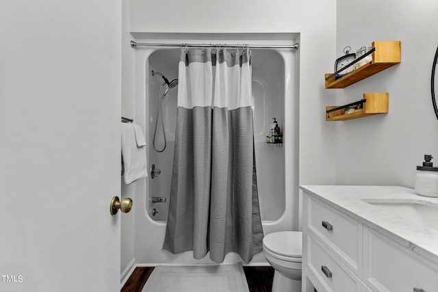 full bathroom with vanity, toilet, wood-type flooring, and shower / tub combo