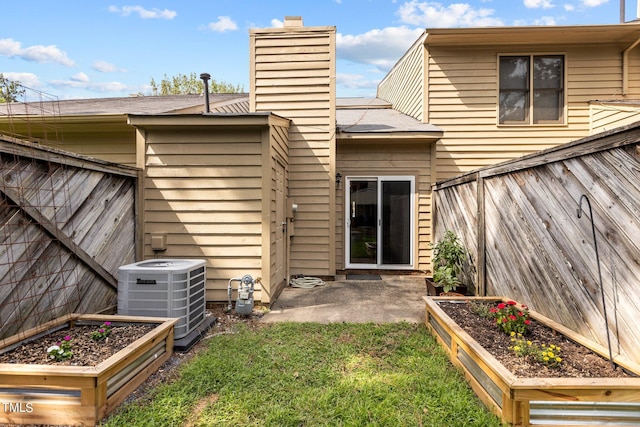 back of house featuring a patio area and cooling unit