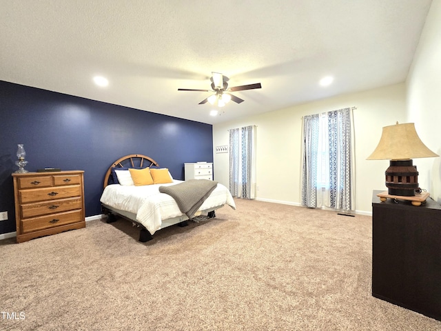 bedroom featuring carpet flooring, a textured ceiling, and ceiling fan