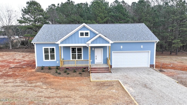 view of front of home featuring a porch and a garage