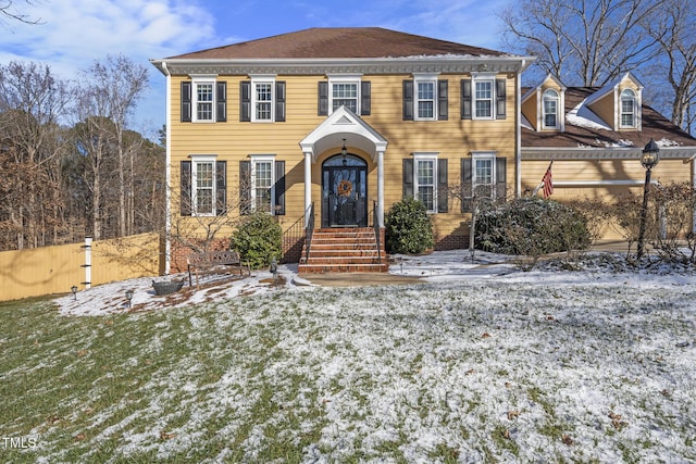 colonial inspired home featuring a lawn