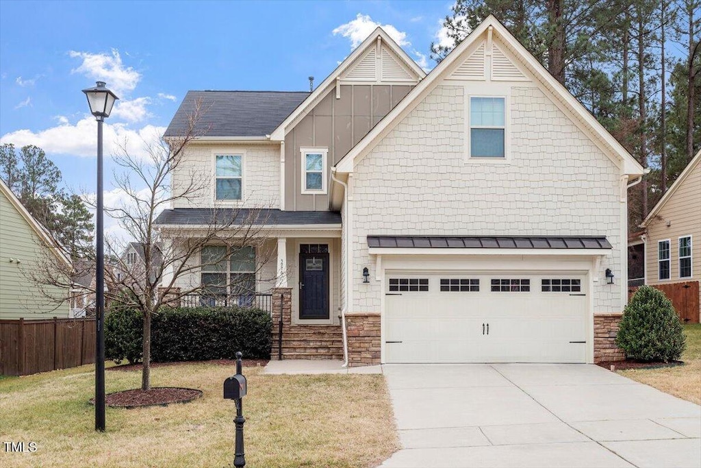 view of front of property with a garage and a front lawn