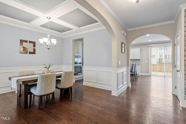 dining space featuring an inviting chandelier, ornamental molding, dark wood-type flooring, and coffered ceiling