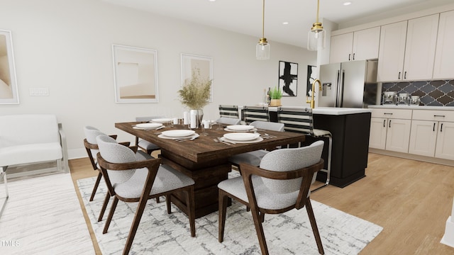 dining space with recessed lighting and light wood-style floors