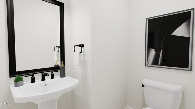 bathroom with toilet and a sink