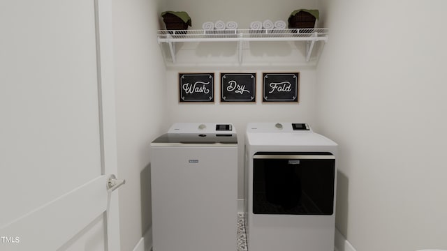 clothes washing area featuring washing machine and clothes dryer and laundry area