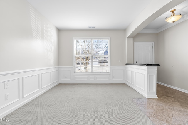 unfurnished dining area featuring light carpet