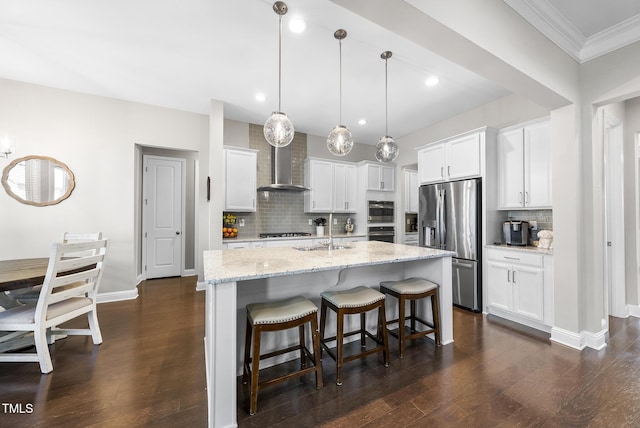 kitchen featuring appliances with stainless steel finishes, decorative backsplash, dark wood-style floors, and wall chimney exhaust hood