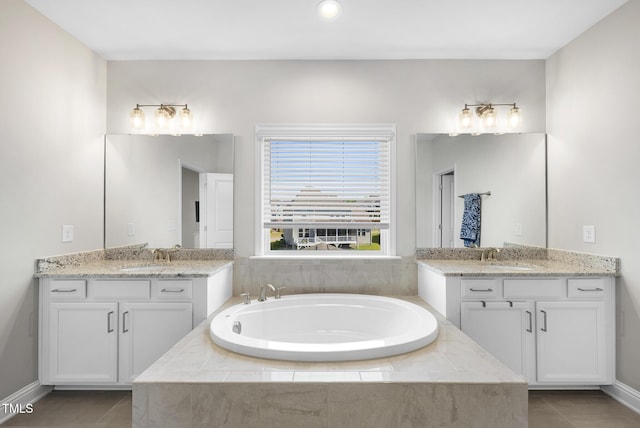 bathroom with a sink, tile patterned floors, a garden tub, and two vanities