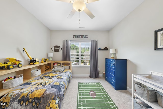 carpeted bedroom featuring baseboards, a ceiling fan, and visible vents